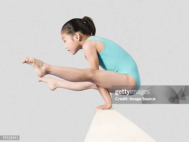 girl on a balance beam - kids gymnastics stock pictures, royalty-free photos & images