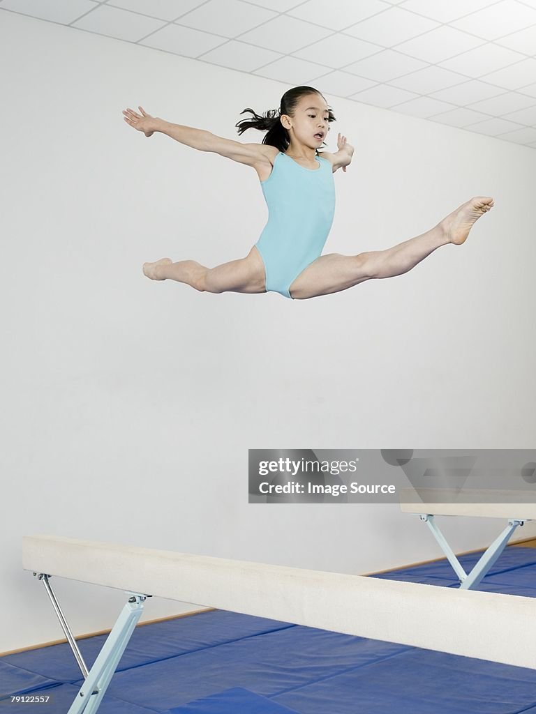 Jumping Balance Girl Jumping Above Balance Beam High-Res Stock Photo - Getty Images