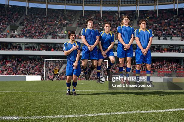 footballers defending a free kick - free kick stock pictures, royalty-free photos & images