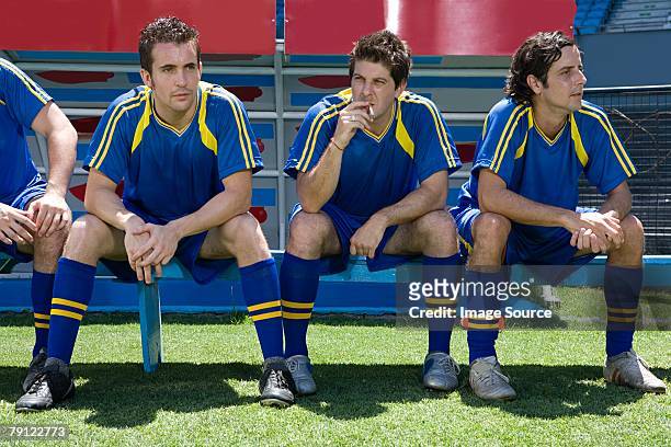 reserve footballer smoking a cigarette - soccer sideline stock pictures, royalty-free photos & images