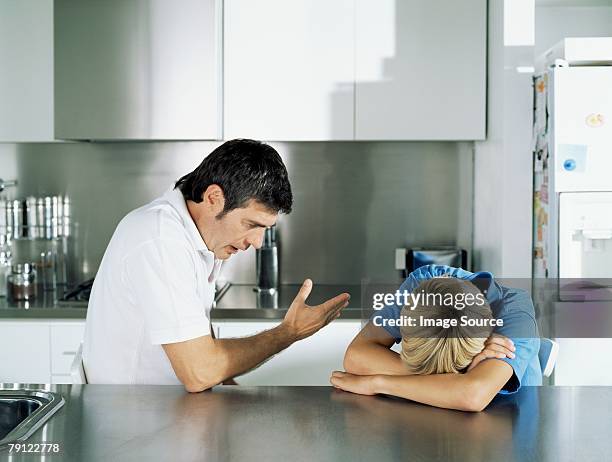 father scolding son - embarrased dad stockfoto's en -beelden