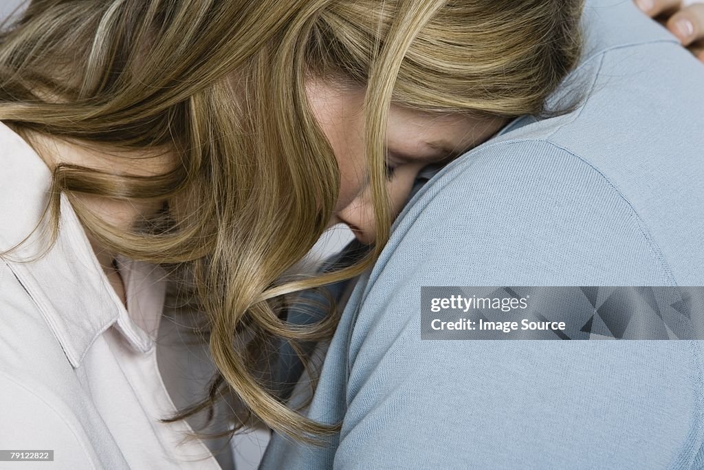 Woman being consoled