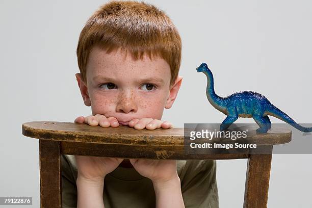 boy with toy dinosaur - dinosaur toy i stock pictures, royalty-free photos & images