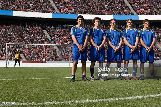 footballers defending a free kick - male crotch stock pictures, royalty-free photos & images