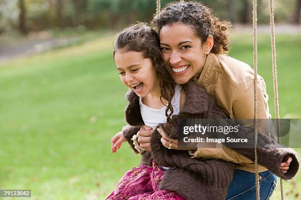 mother and daughter on swing - mom and young daughter stockfoto's en -beelden