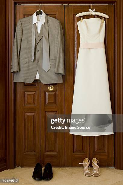 wedding dress and suit - suits hanging stock pictures, royalty-free photos & images