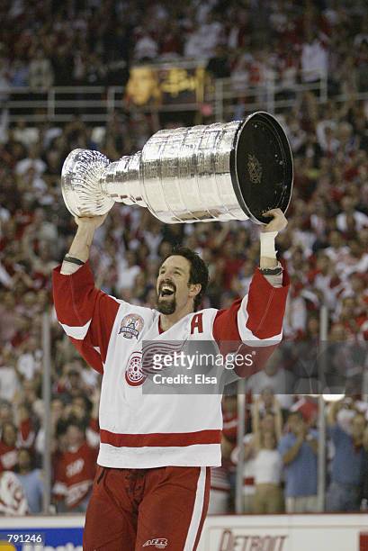 Brendan Shanahan of the Detroit Red Wings raises the Stanley Cup after eliminating the Carolina Hurricanes during game five of the NHL Stanley Cup...
