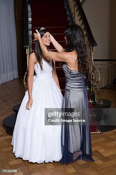 mother placing tiara on daughters head - quinceanera party stock pictures, royalty-free photos & images