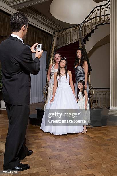 man photographing quinceanera and family - quinceanera party stock pictures, royalty-free photos & images