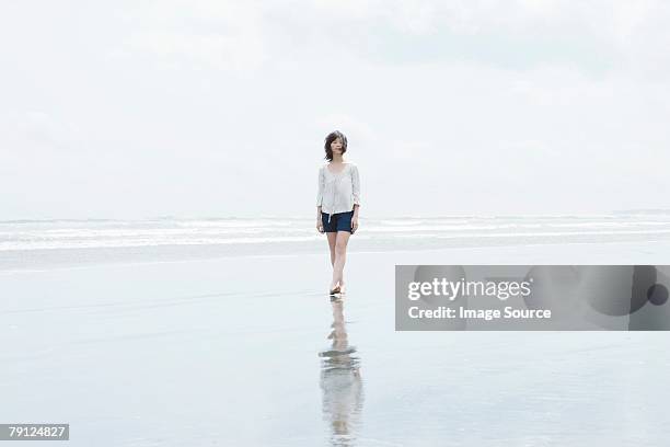 woman walking by the sea - wade bildbanksfoton och bilder