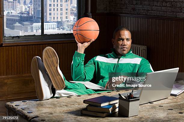man at desk with basketball - track suit stock pictures, royalty-free photos & images