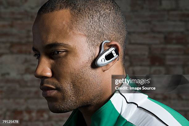 man with hands free device - bluetooth stock pictures, royalty-free photos & images