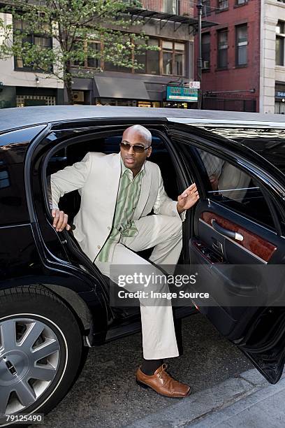 man getting out of limousine - best sunglasses for bald men stock pictures, royalty-free photos & images