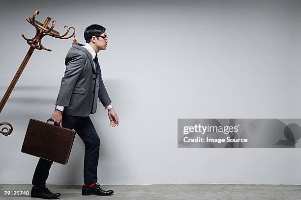 a businessman attached to a hatstand - professional drag stock pictures, royalty-free photos & images