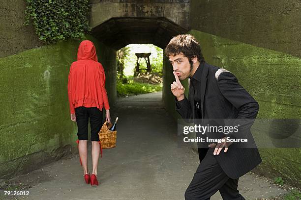 man following little red riding hood - underpass stock pictures, royalty-free photos & images