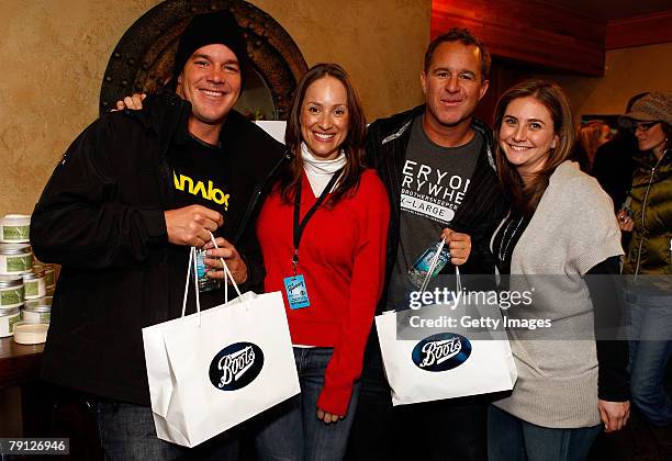 Surfers Koby Abberton and Sunny Abberton pose with the Boots display at the Gibson Guitar celebrity hospitality lounge held at the Miners Club during...