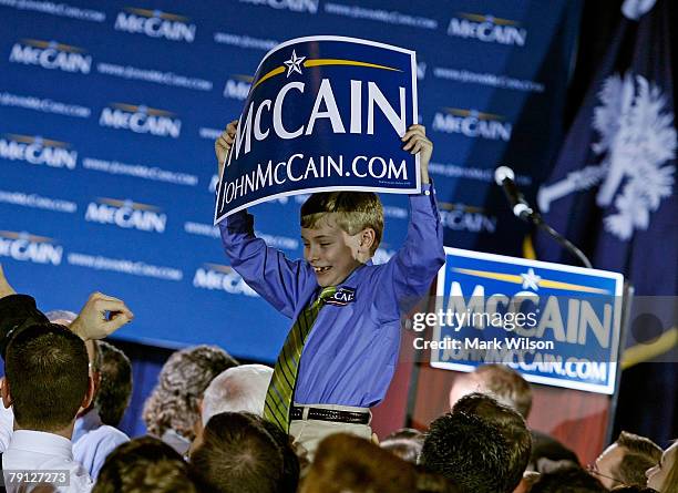 Eight year old Townes Holland is lifted above the crowd during Presidential hopeful Sen. John McCain's post-primary campaign rally at alumni hall of...