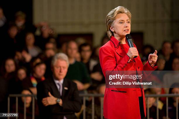 Democratic presidential hopeful Sen. Hillary Clinton speaks as Former President Bill Clinton looks on at a town hall meeting following the Nevada...