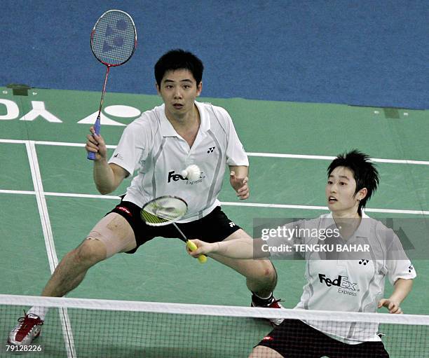 China's mixed doubles pair Yu Yang and He Hanbin return a shot against South Korea's Lee Yong Dae and Lee Hyo Jung during their mixed doubles finals...