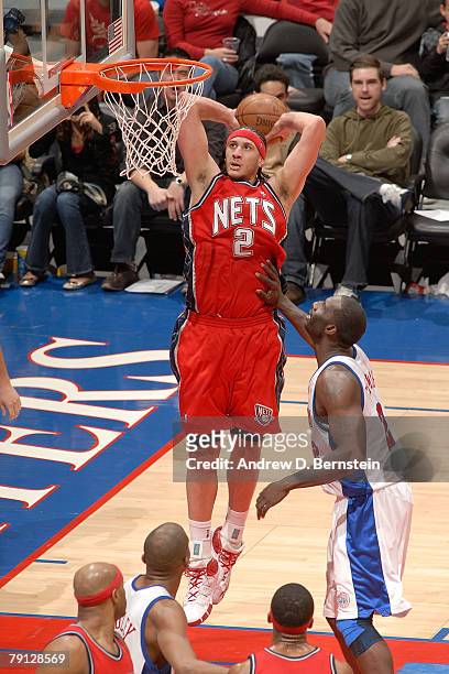Josh Boone of the New Jersey Nets goes up for a dunk against Tim Thomas of the Los Angeles Clippers at Staples Center on January 19, 2008 in Los...
