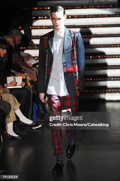 Model walks the catwalk during the Comme Des Garcons Homme Plus Menswear fashion show part of Paris Fashion Week on the 18th of January 2008 in...