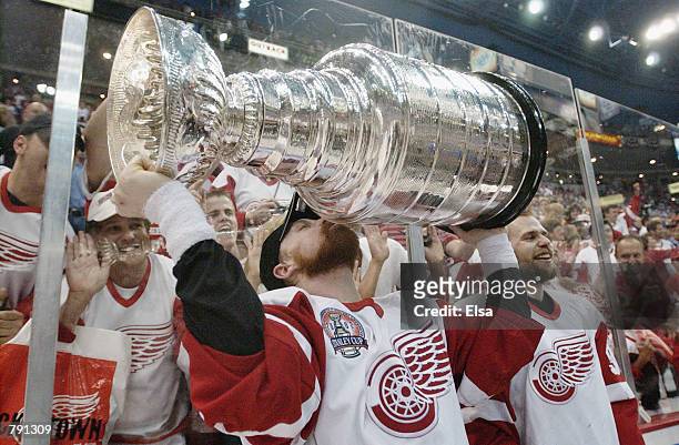 Kris Draper of the Detroit Red Wings kisses the Stanley Cup after eliminating the Carolina Hurricanes during game five of the NHL Stanley Cup Finals...