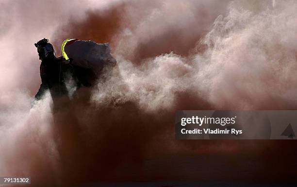 Parachute diver walks in the finish area after his show jump prior to the Alpine FIS Ski World Cup Men's Slalom on January 20, 2008 in Kitzbuehel,...