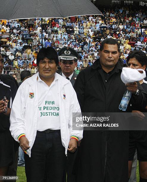 Bolivian president Evo Morales and Paraguayan former goalie Jose Luis Chilavert leave the field during the inauguration of a football summer...