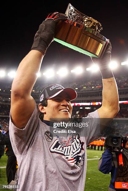 Tedy Bruschi of the New England Patriots celebrates with the Lamar Hunt Trophy after defeating the San Diego Chargers by a score of 21-12 to win the...