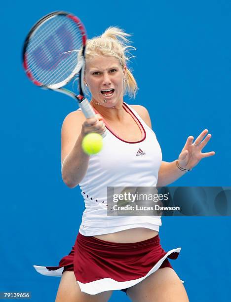 Isabella Holland of Australia plays a forehand during her junior doubles match with Sally Peers of Australia against Simona Halep of Romania and...