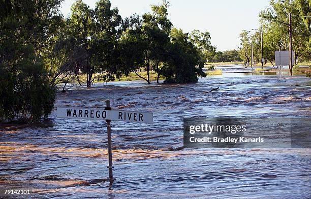 The Warrego River is seen floaded as the Mitchell Highway is cut off by flood waters and a man made barrier has been built to try an prevent further...