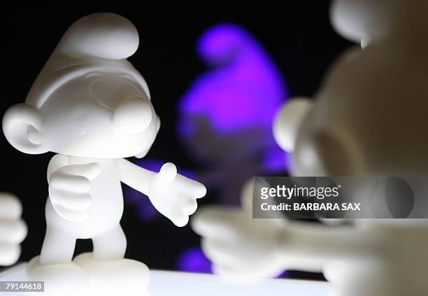 Figurines of smurfs are on display during an event 21 January 2008 in Berlin to celebrate the smurfs' 50th anniversary. The smurfs were invented by...