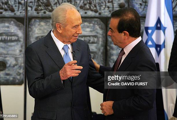 President of French automaker Renault-Nissan, Carlos Ghosn talks with Israeli President Shimon Peres following a joint press conference with Director...