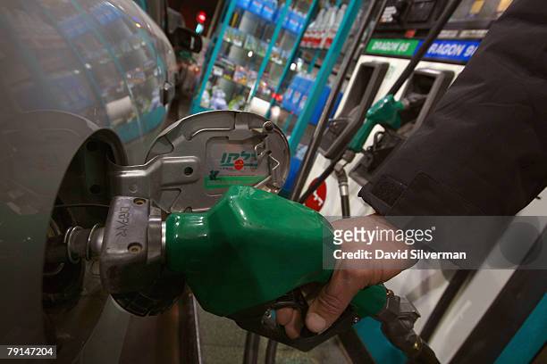 An attendant fills up a car at a gasoline station January 21, 2008 in Raanana in central Israel. Israel announced plans to promote electric cars on a...