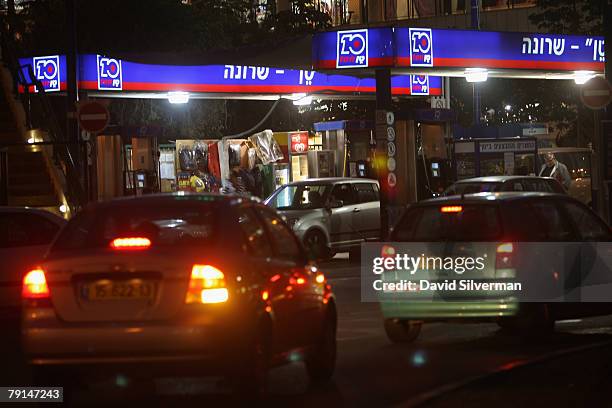 Drivers fill up at a gasoline station January 21, 2008 in Raanana in central Israel. Israel announced plans to promote electric cars on a large-scale...