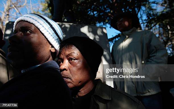 People stand listening to speakers on the grounds of the South Carolina State House during a Martin Luther King Day rally January 21, 2008 in...