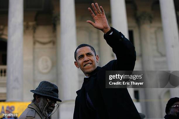 Presidential candidate U.S. Senator Barack Obama waves to the crowd during a Martin Luther King Day rally at the state capitol January 21, 2008 in...