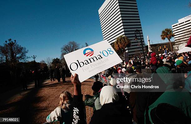 Supporter of Barack Obama waves a sign for him during a Martin Luther King day rally on the grounds of the South Carolina State House January 21,...