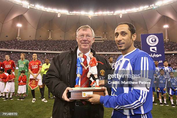 Sir Alex Ferguson of Manchester United presents Sami Al-Jaber with a memento ahead of Sami Al-Jaber's testimonial friendly match between Al Hilal...
