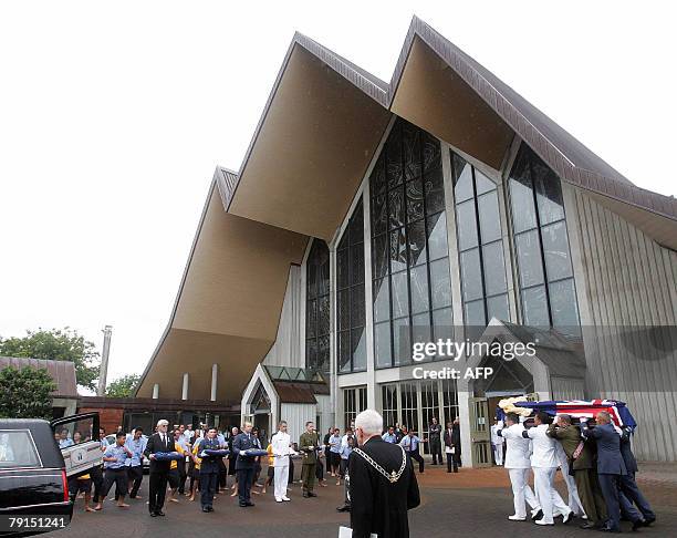 Draped in a New Zealand flag, Sir Edmund Hillary's casket leaves the church following his funeral in Auckland, 22 January 2008. New Zealand paid...