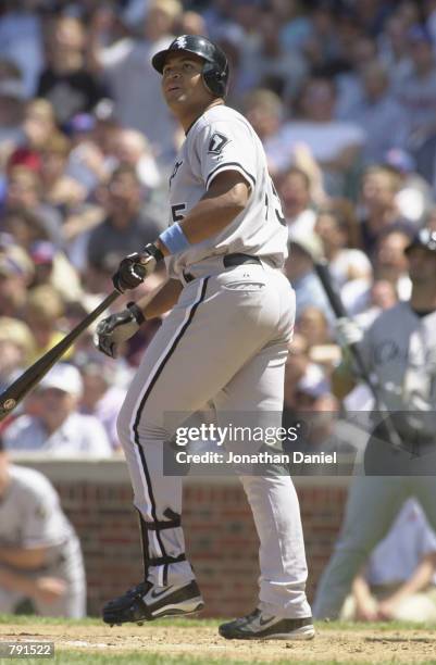 Left fielder Carlos Lee of the Chicago White Sox watches as his grand slam home run sails out of the park in the 3rd inning against the Chicago Cubs...