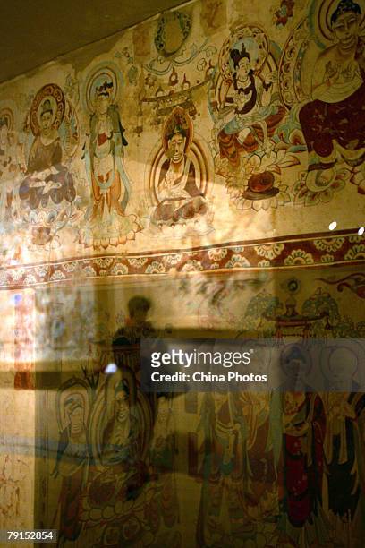 Visitor views replica of parts of the Mogao Cave during the Dunhuang Art Exhibition at the National Art Museum of China on January 21, 2008 in...