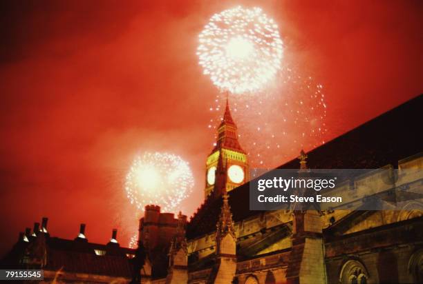 Fireworks exploding against a red sky over the Houses of Parliament and Big Ben as part of New Year's Eve celebrations to mark the new Millenium,...