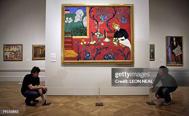 Gallery assistants arrange a barrier around a painting entitled "The Red Room " by French artist Henri Matisse during an exhibition entitled "From...