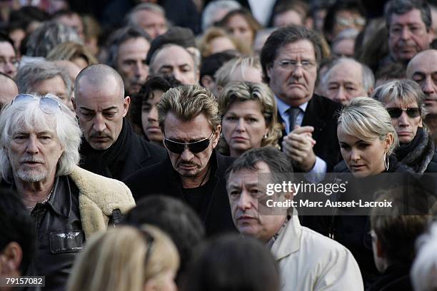 Johnny Hallyday and his wife Laeticia leave the St Germain church after the funeral mass of French singer Carlos on January 22, 2008 in Paris, France.