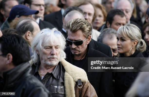 Johnny Hallyday and his wife Laeticia leave the St Germain church after the funeral mass of French singer Carlos on January 22, 2008 in Paris, France.