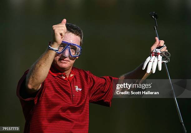 Woody Austin of the U.S. Team walks to the 14th green wearing a dive mask during the final day singles matches at The Presidents Cup at The Royal...