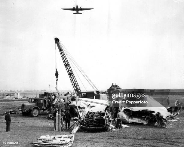 Crane removing the wreckage of the BEA Elizabethan airliner G-ALZU 'Lord Burghley' from Reim airport, Munich, where 23 people lost their lives...