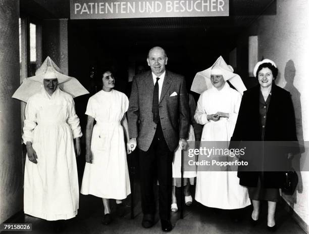 Manchester United Manager Matt Busby leaving the Der Isar hospital, Munich, with his wife Jean and members of the nursing staff, after being injured...