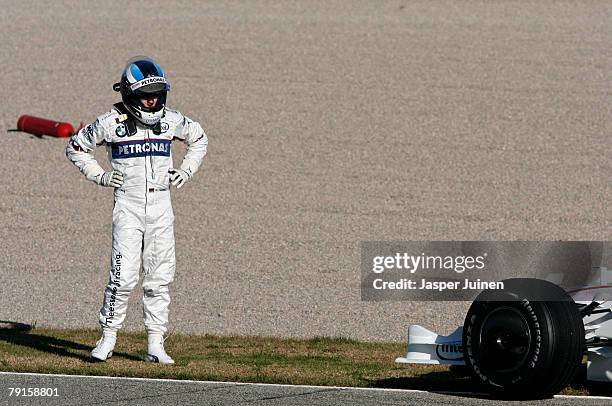 Nick Heidfeld of Germany and team BMW Sauber stands near his car after it failed during Formula one testing at the Ricardo Tormo racetrack on January...